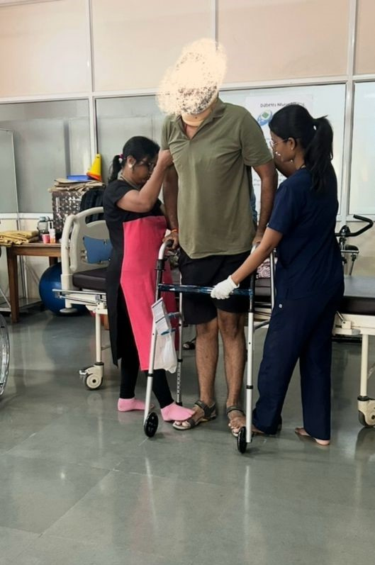 A therapist supporting a patient relearning to walk